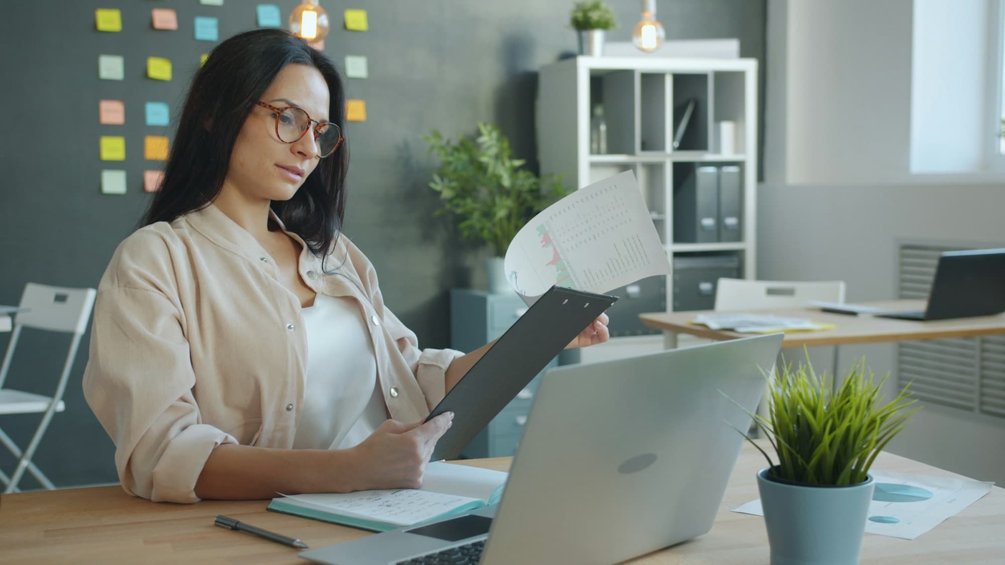A banking operations reviewer reading account paperwork